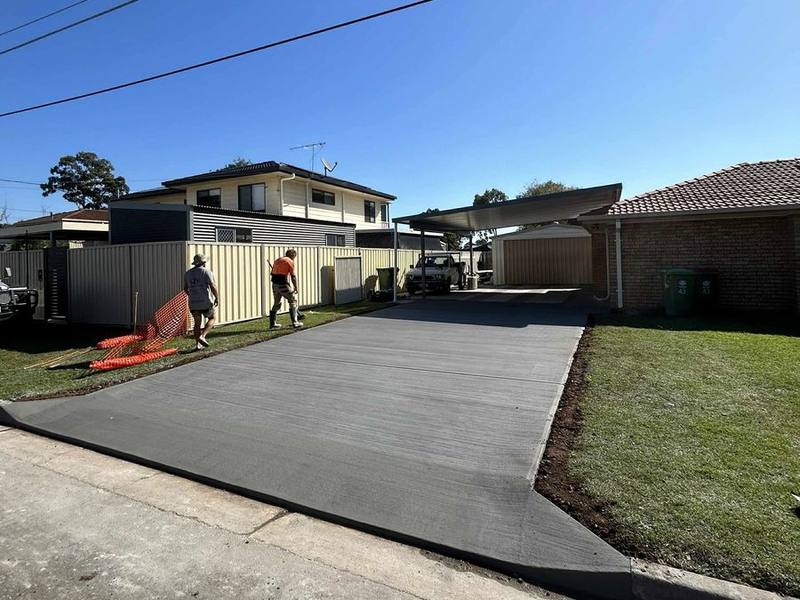 New concrete driveway at a brick home